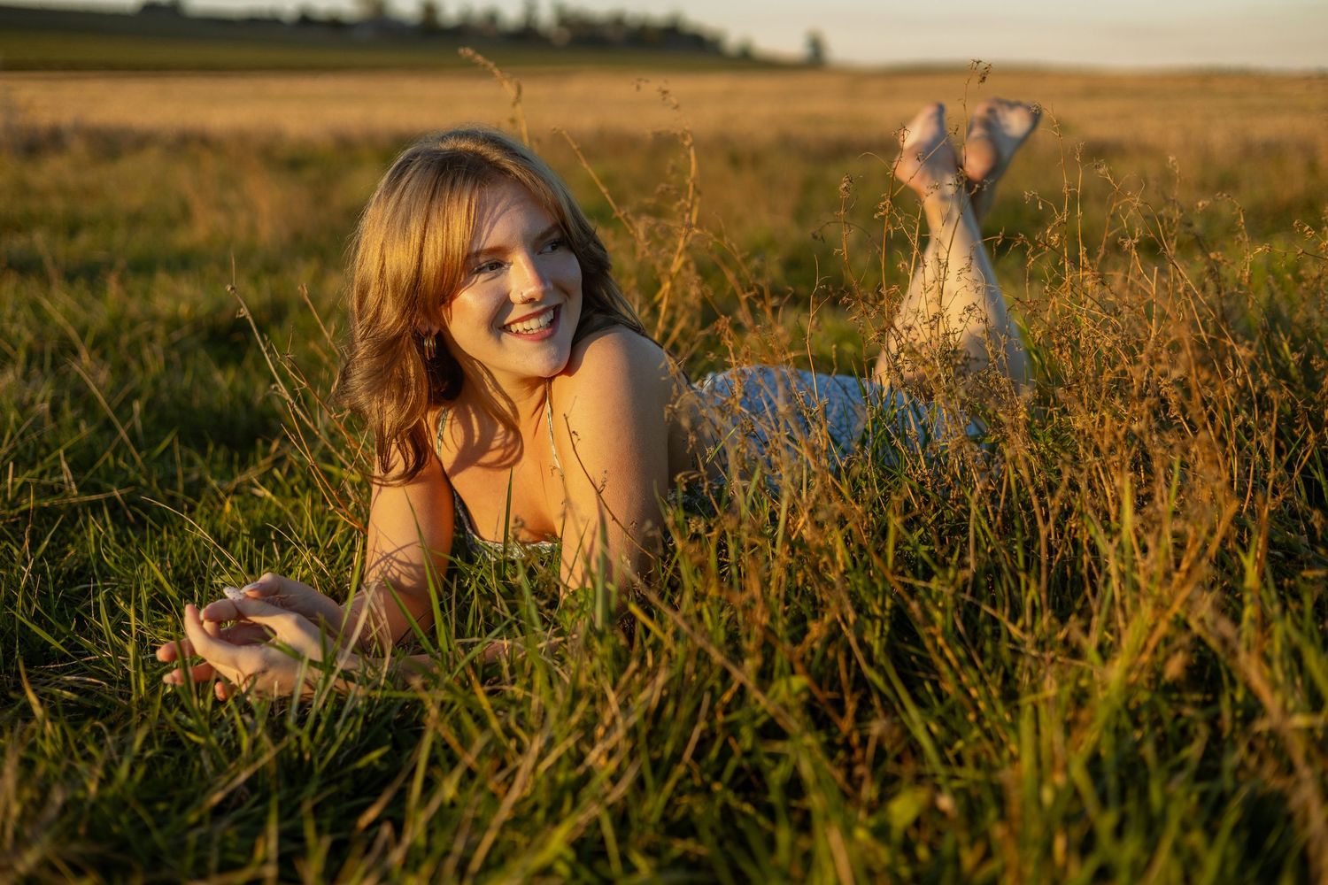 Family in a field at sunset with two kids running towards the camera and laughing at Fort Ebey on Whidbey Island.