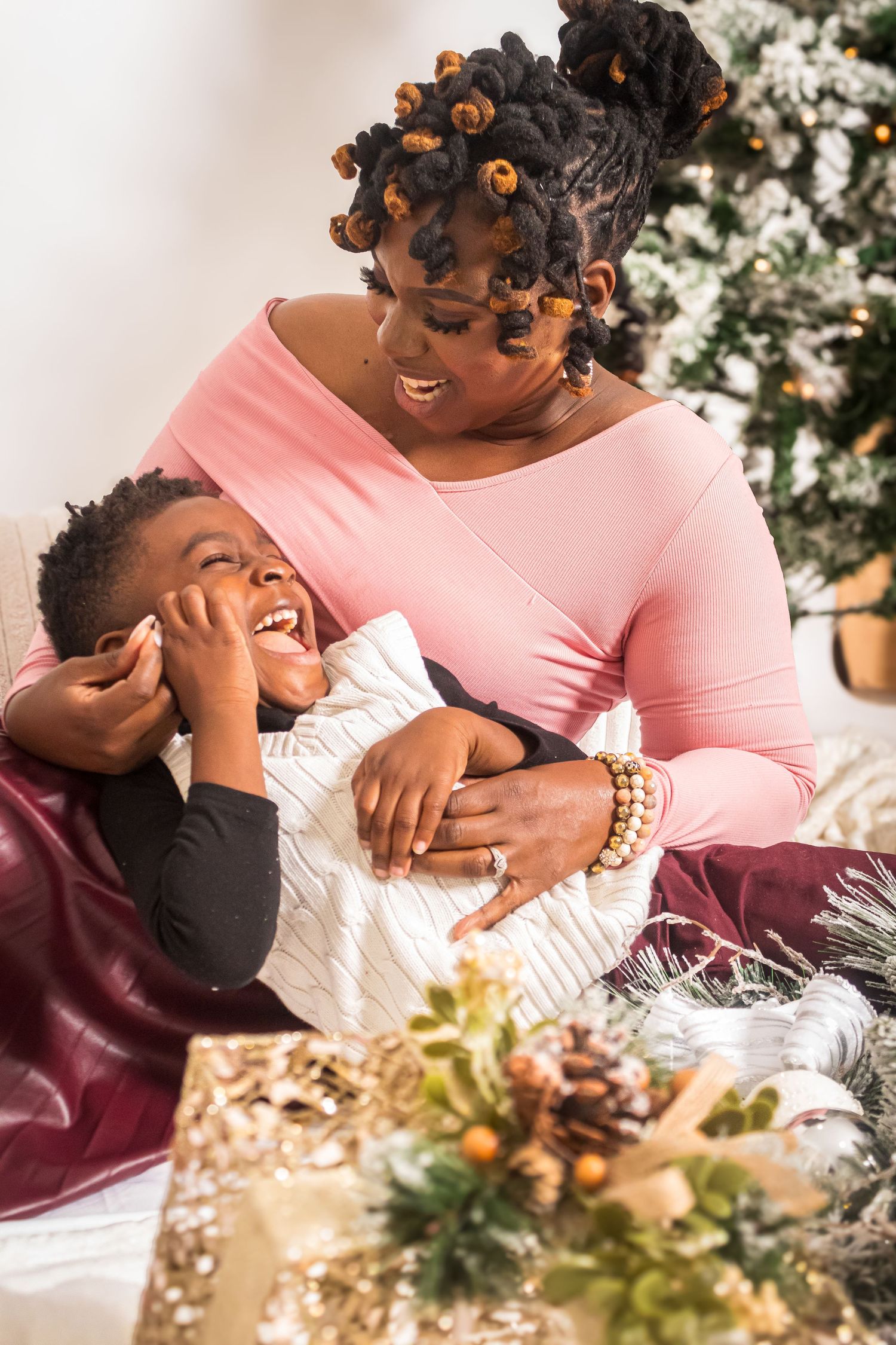Mother and child share a joyful moment while celebrating Christmas together.