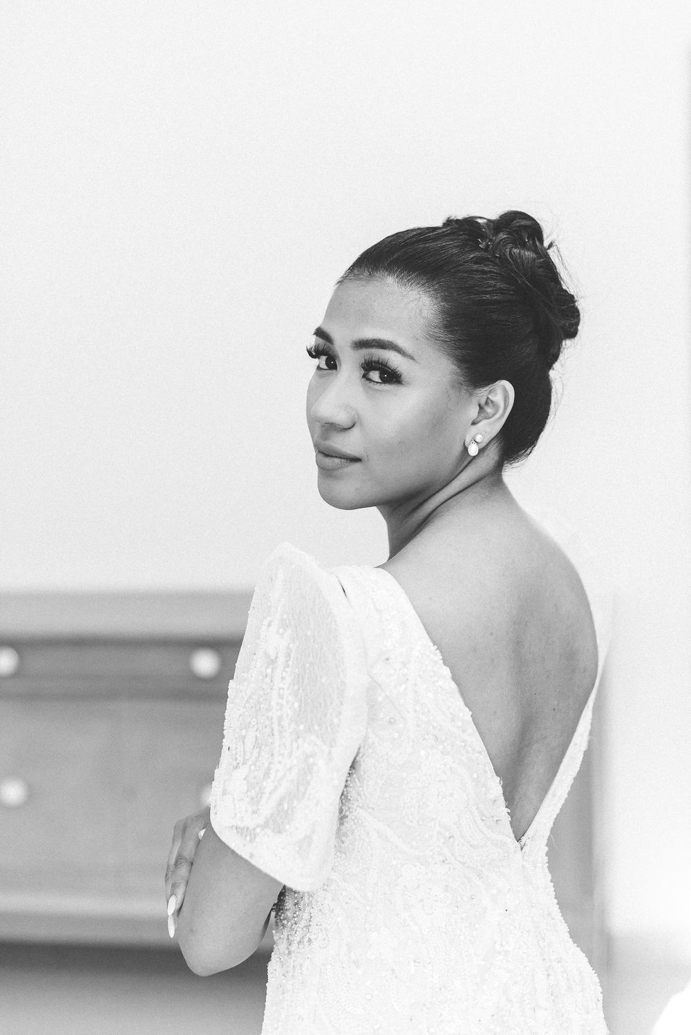 Black and white portrait series showing various side profile poses and angles of a woman with hair in a bun.