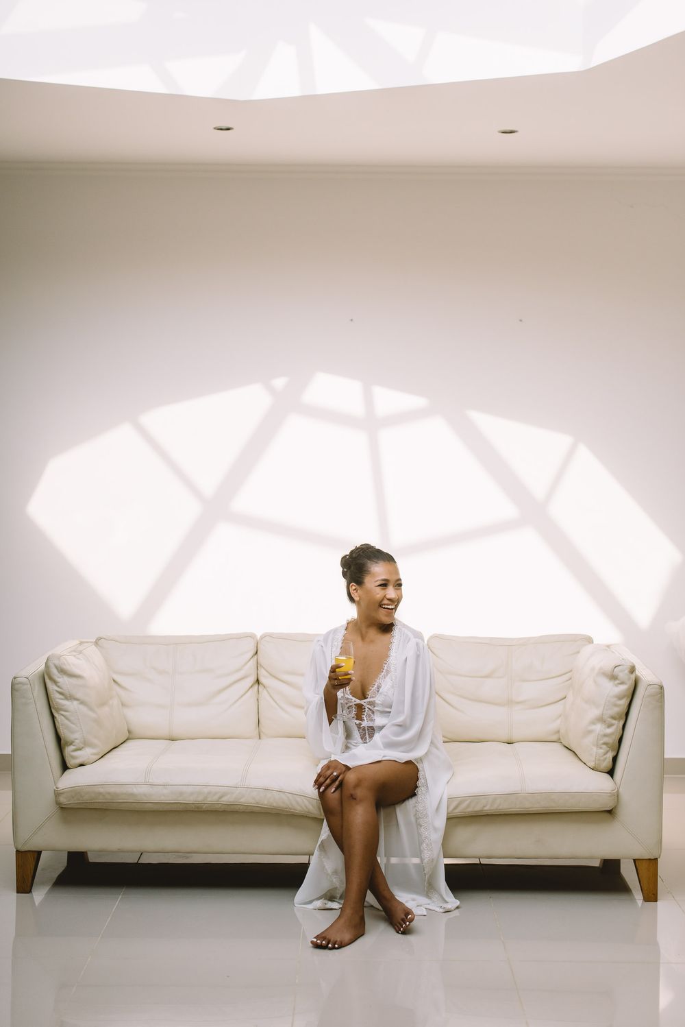White couch series showing movement and flow in a minimalist studio setting with natural lighting.