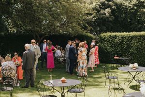 Wedding guests mingle and socialise at an outdoor garden reception at Saltmarshe Hall - taken by Grimsby photographer.