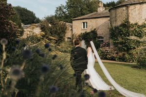 Bride and groom walking across the lawn at Saltmarshe Hall - taken by Grimsby photographer.