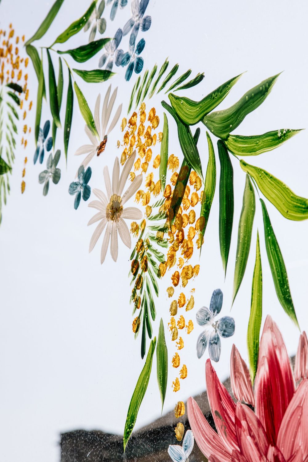Watercolor floral design featuring green palm leaves, pink flowers, and golden berries against a white background.