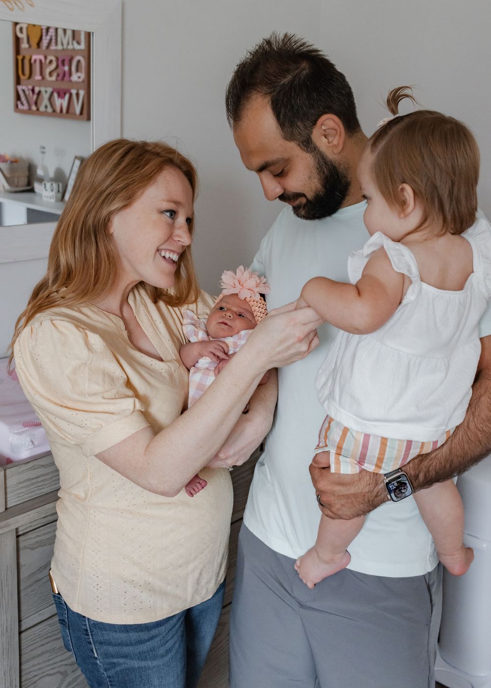 Family sharing joyful moments together in bright indoor setting.