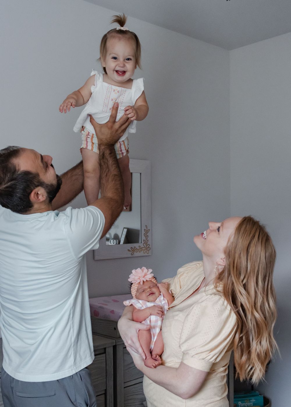 Parents playfully lifting and interacting with baby in a joyful sequence of photos.