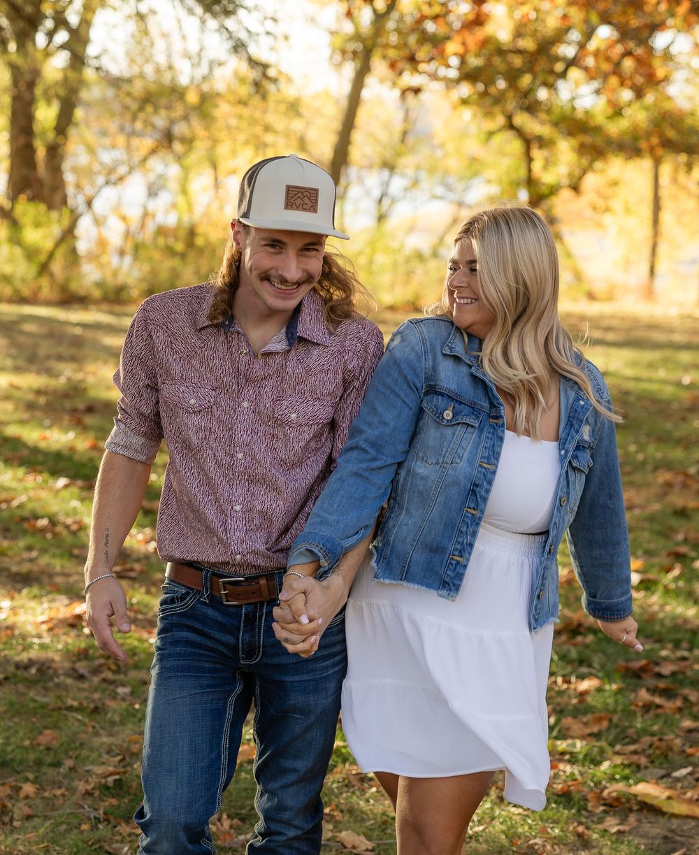 Romantic autumn couple portraits with golden sunlight filtering through trees.