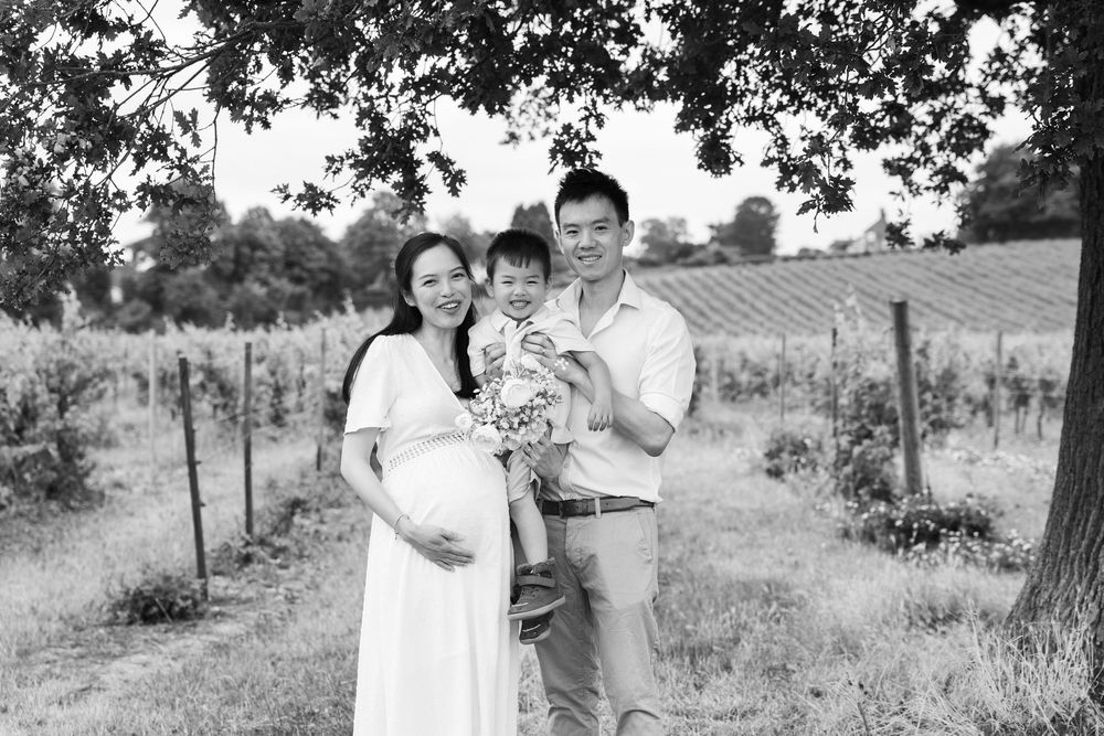 Montage of black and white family portraits in rural outdoor settings with trees and fields in the background.