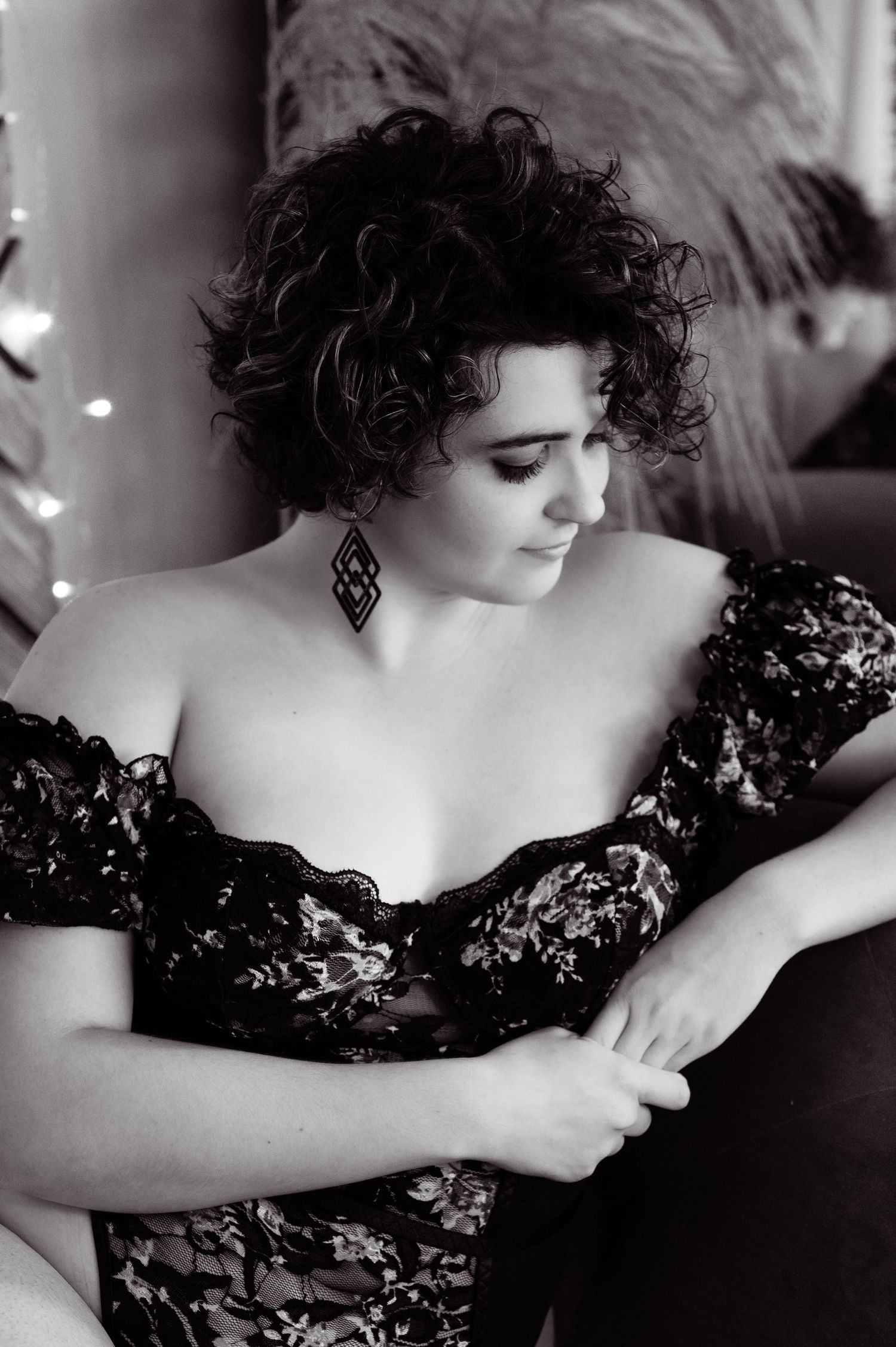 Vintage-style black and white portrait with lace details and dramatic lighting.