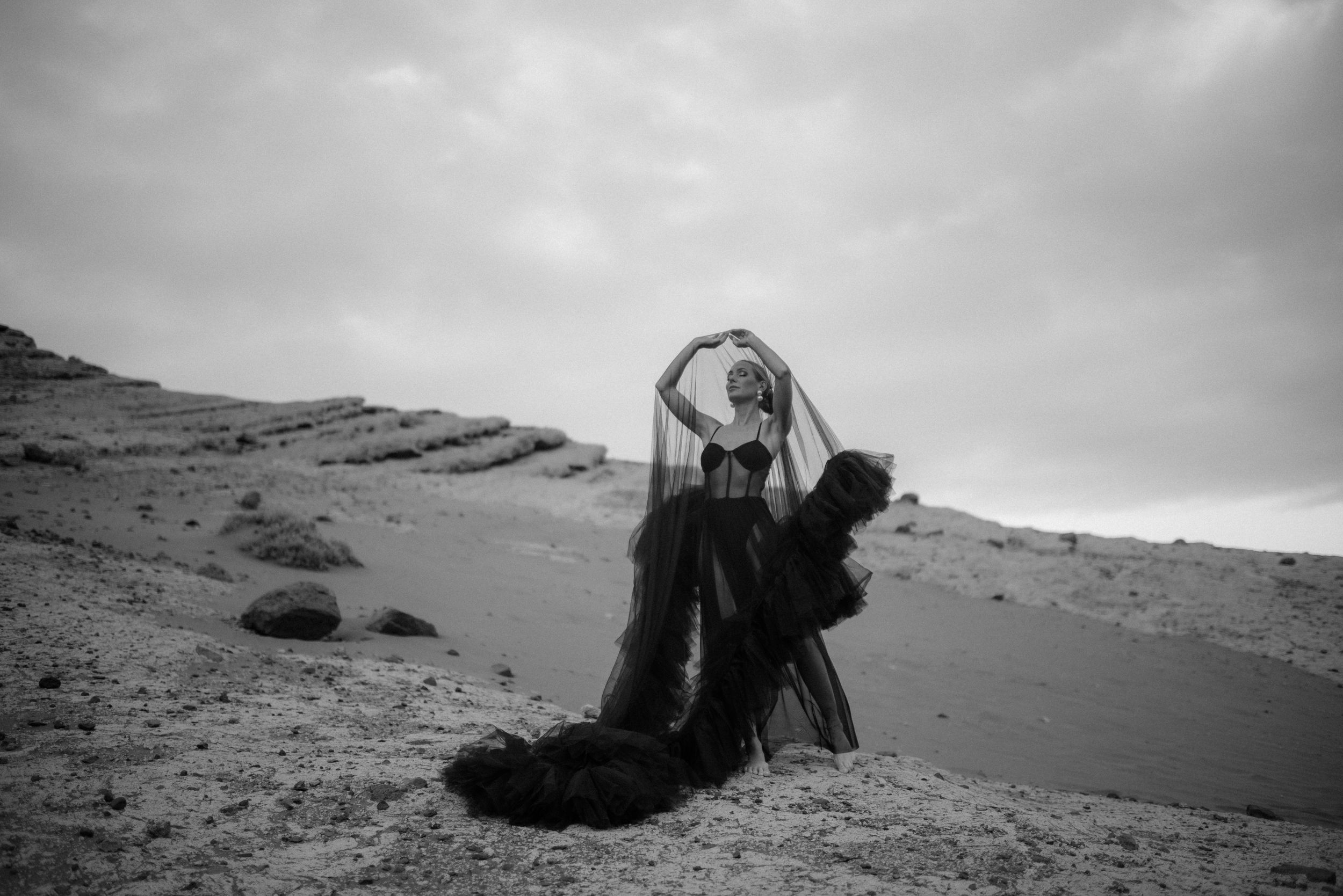 A series of black and white photographs showing dramatic desert landscapes with rocky cliffs and dunes in the south of Tenerife.