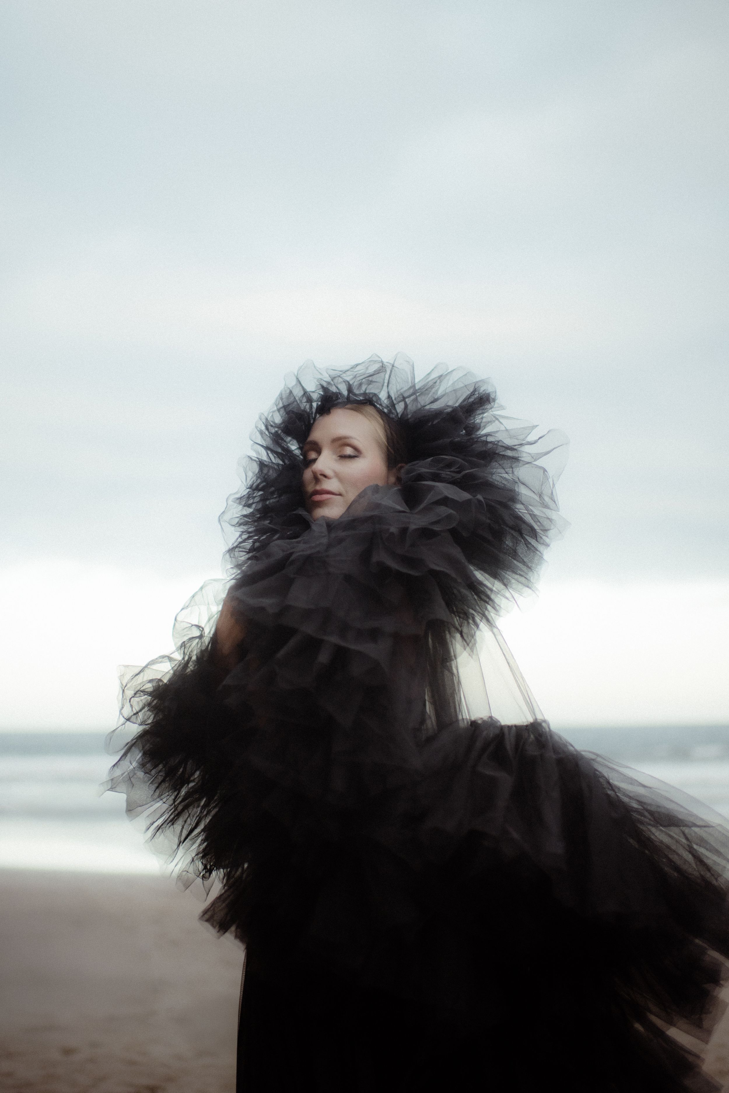 A sequence of artistic coastal portraits featuring flowing black tulle fabric against an overcast sky in the south of Tenerife.