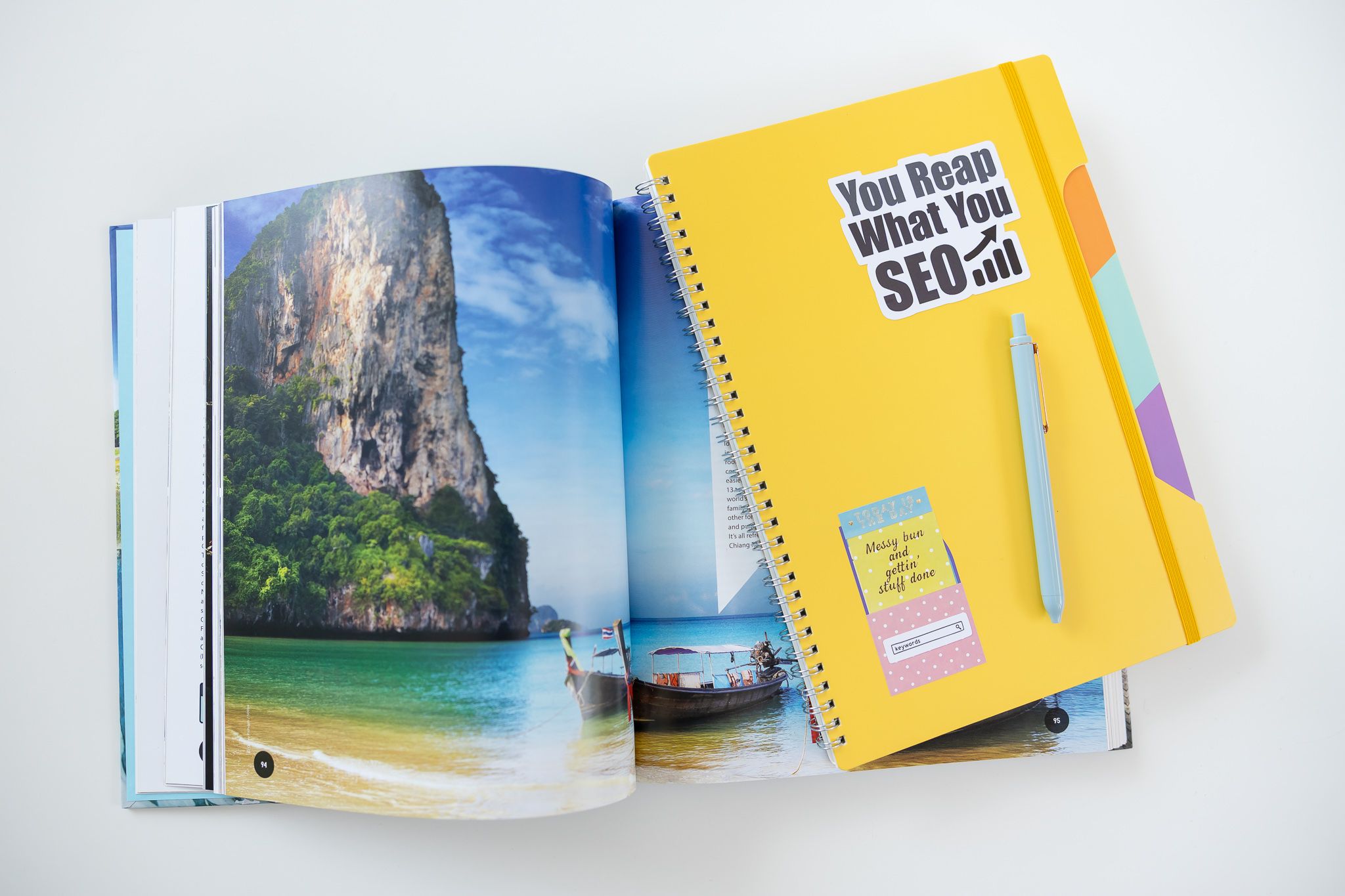 Jessica Stegner Seattle SEO consultant woman business owner branding travel magazine and yellow SEO sticker notebook on white table