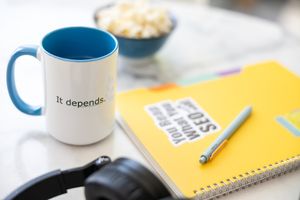 Jessica Stegner Seattle SEO consultant woman business owner branding stock coffee mug, notebook, pen, bowl of popcorn, headphone on table