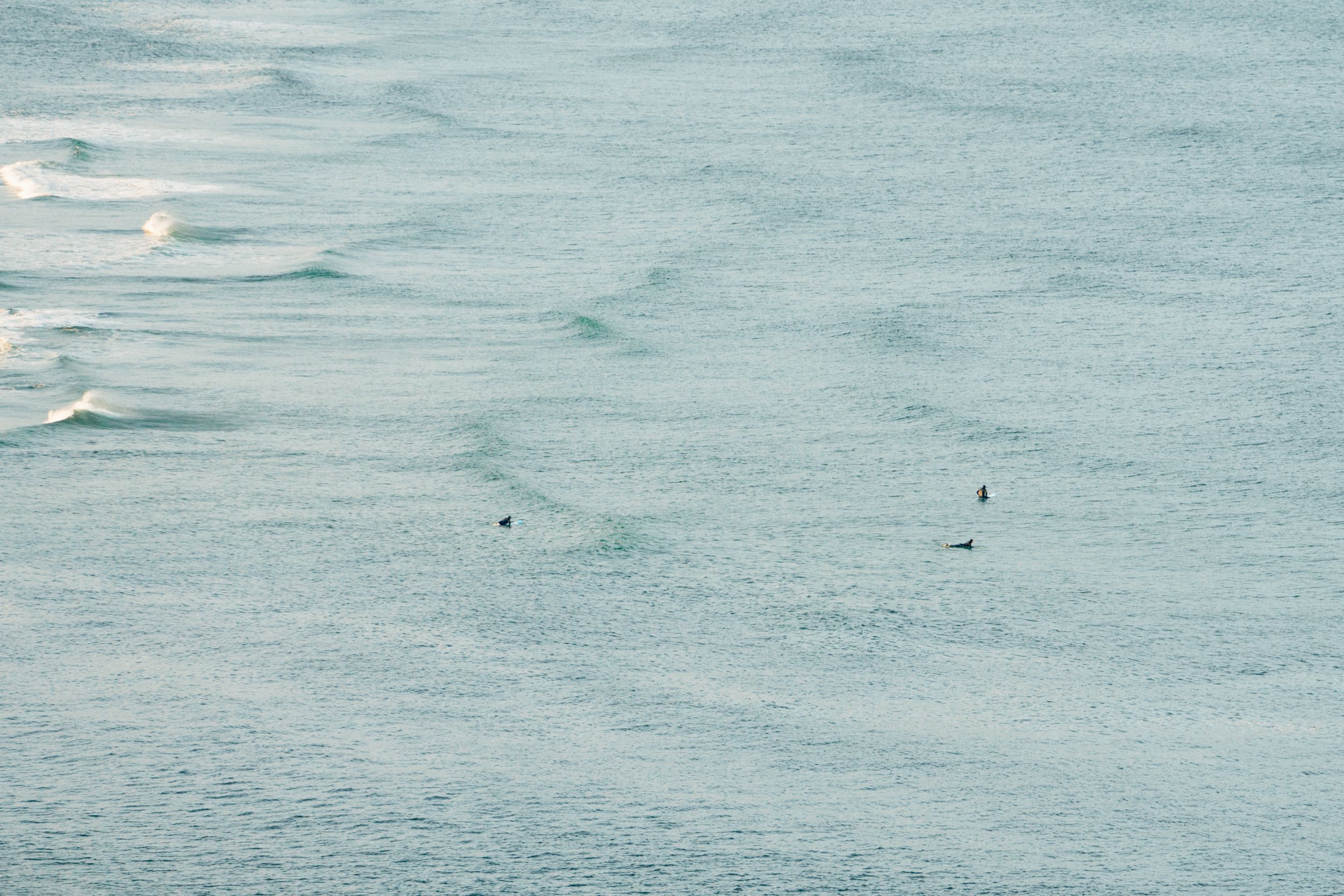 Calm turquoise ocean waters with gentle waves rolling towards shore.