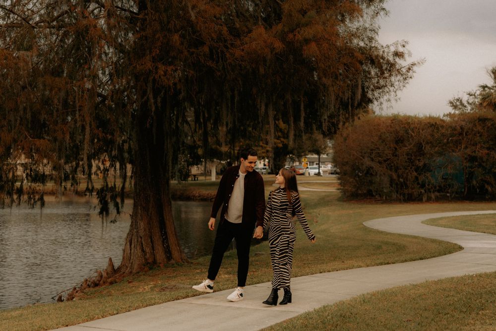 People walking along a park path on an overcast autumn day.