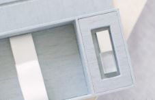 Close-up view of a small rectangular electronic device with a white housing and display window.