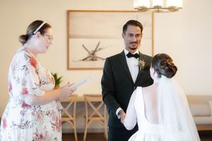 Elegant wedding preparations in a bright room with white decor and natural lighting.