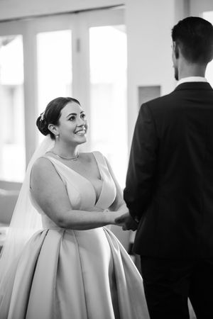 Black and white series capturing candid moments during a wedding celebration.