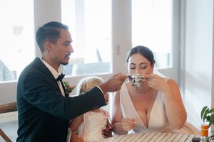 A couple shares a cup of spirits during their wedding ceremony