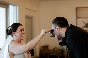 A playful moment between the newlyweds during their wedding celebration.