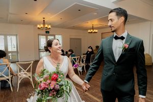 Couple walking together during their wedding celebration in an elegant reception hall.