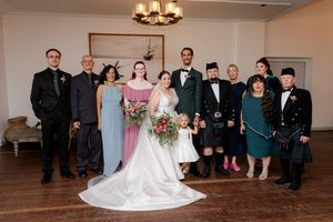 A panoramic view of a wedding ceremony setup in an elegant indoor venue with chandelier lighting.