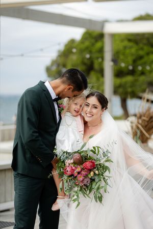 Intimate wedding moments captured in a series of joyful exchanges under a white tent setting.