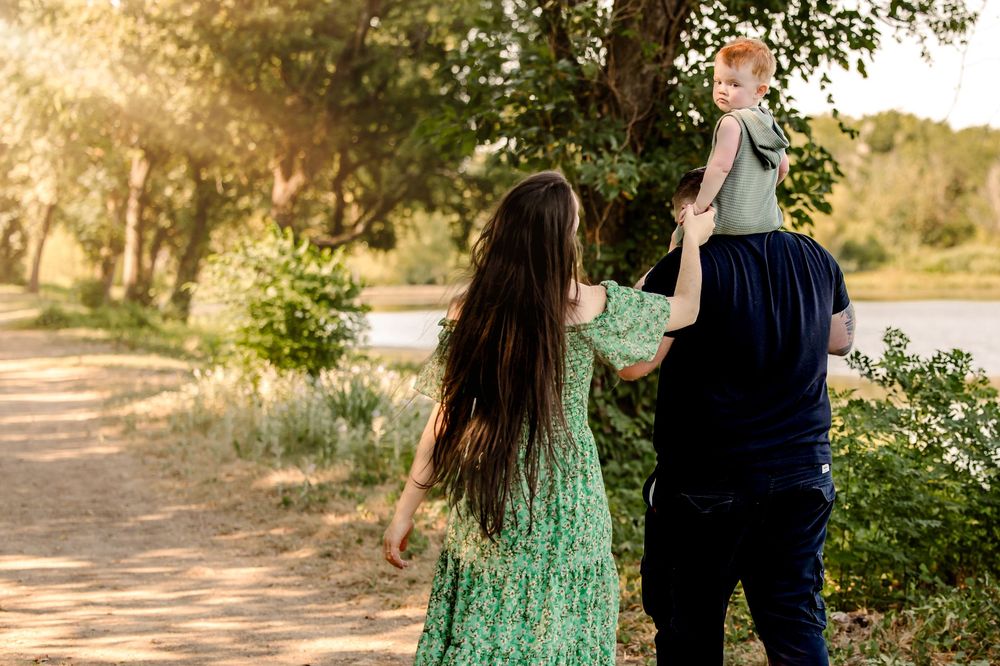 black and white photo of a family walking away from the camera during fort worth maternity photo session