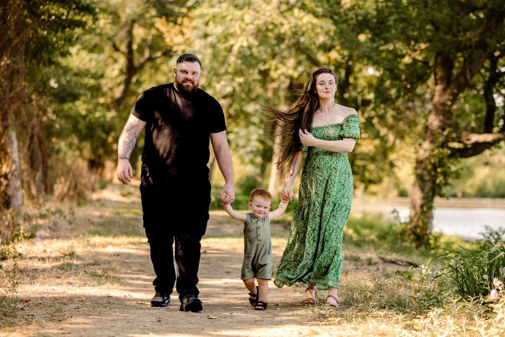 family walks towards the camera holding hands in fort worth park