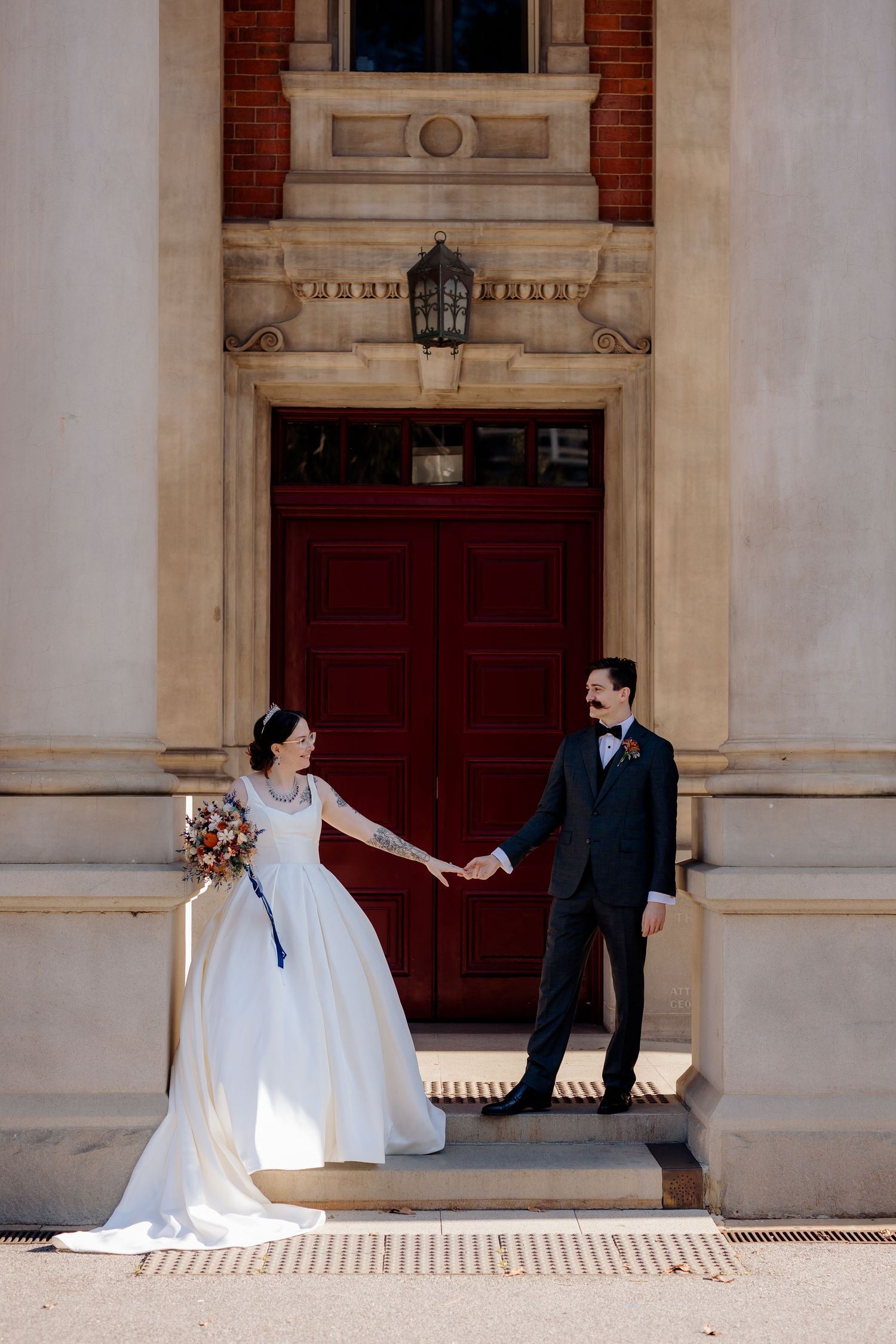 A romantic sequence of wedding photos showing a couple in formal attire playing and posing together against a brick building.