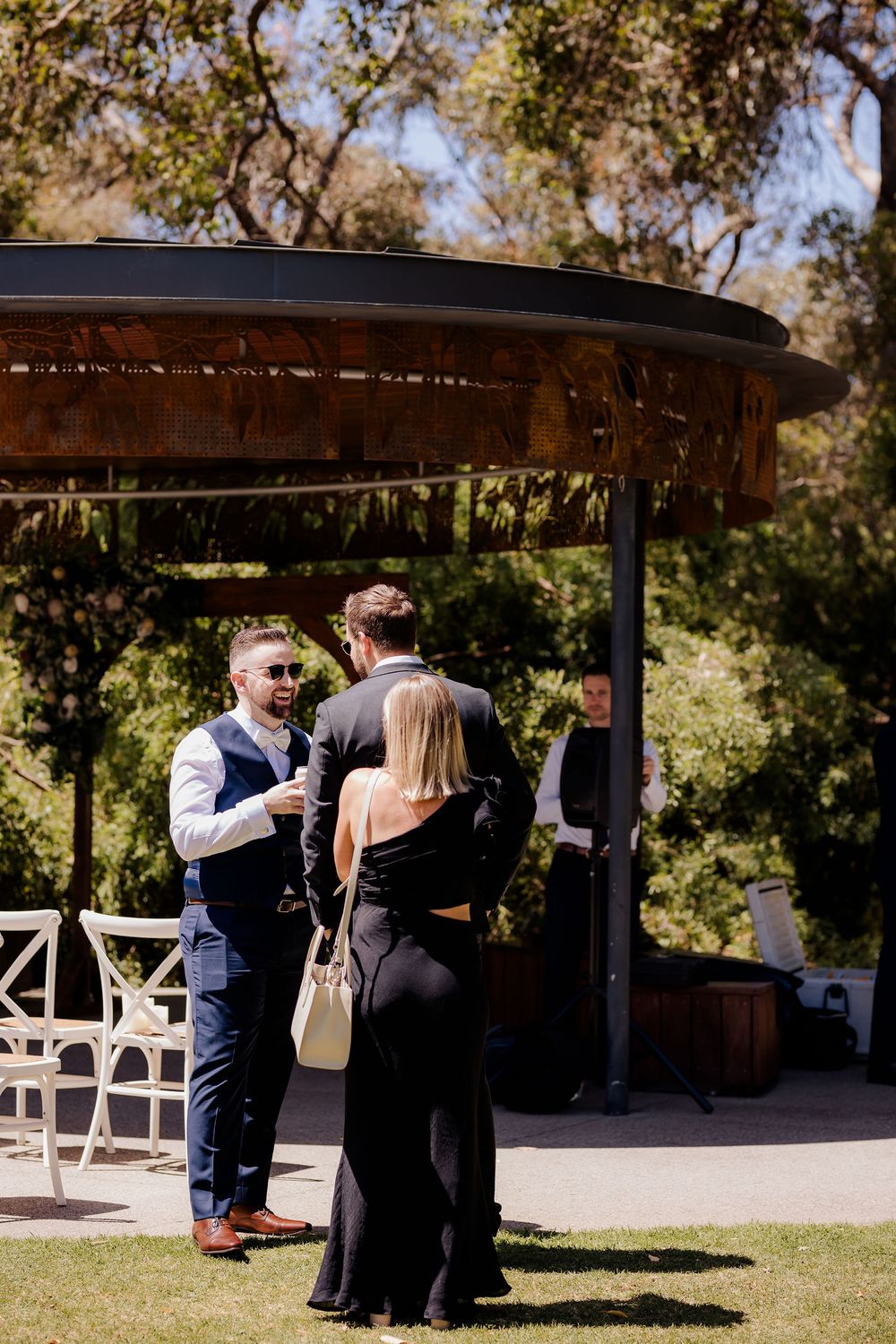 Sequence of wedding photos showing a couple sharing a romantic dance moment under an outdoor wooden pergola.