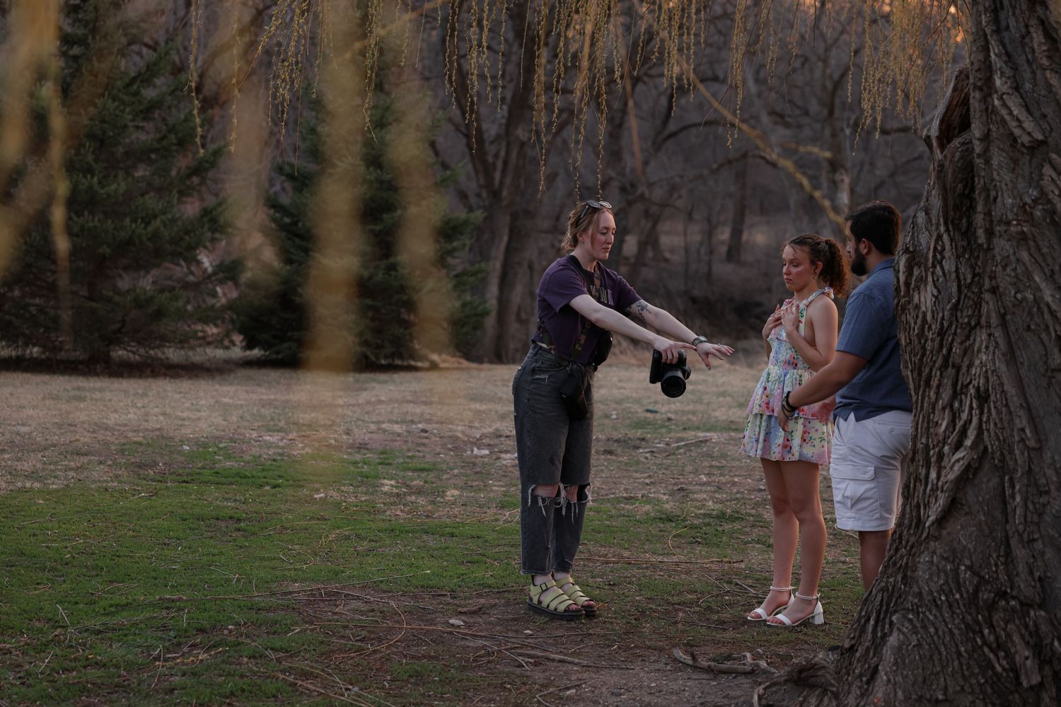 Behind-the-scenes view of photographer documenting proposal in natural outdoor setting.