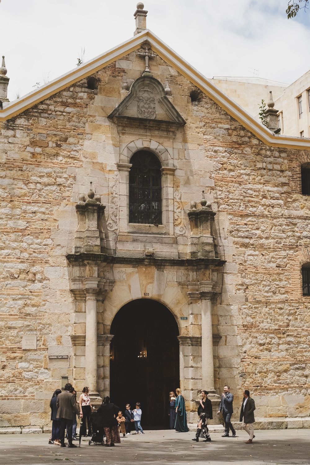 Historic stone church entrance with arched doorway and architectural details in old European style building facade.