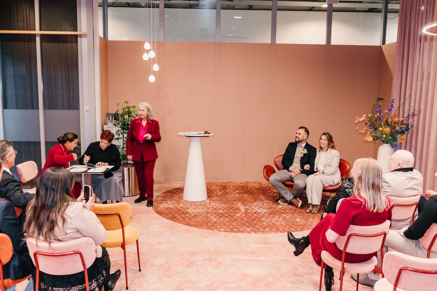 Wedding ceremony with officiant and witnesses signing inside Gemeente Locket Amsterdam Oost
