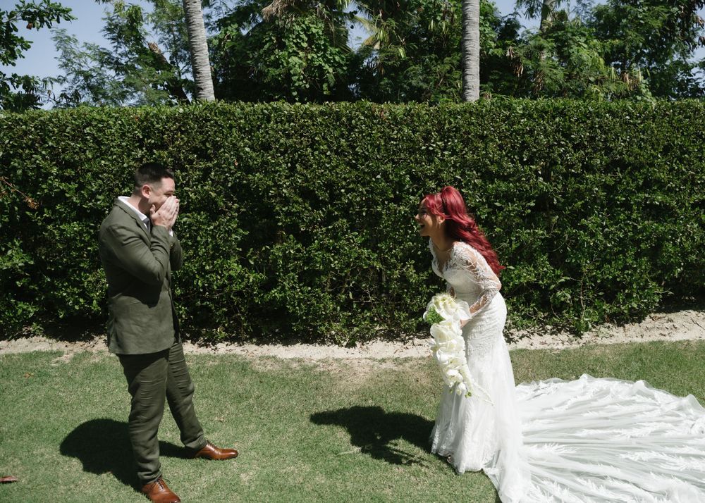 Emotional wedding ceremony moment in garden with tropical landscaping.