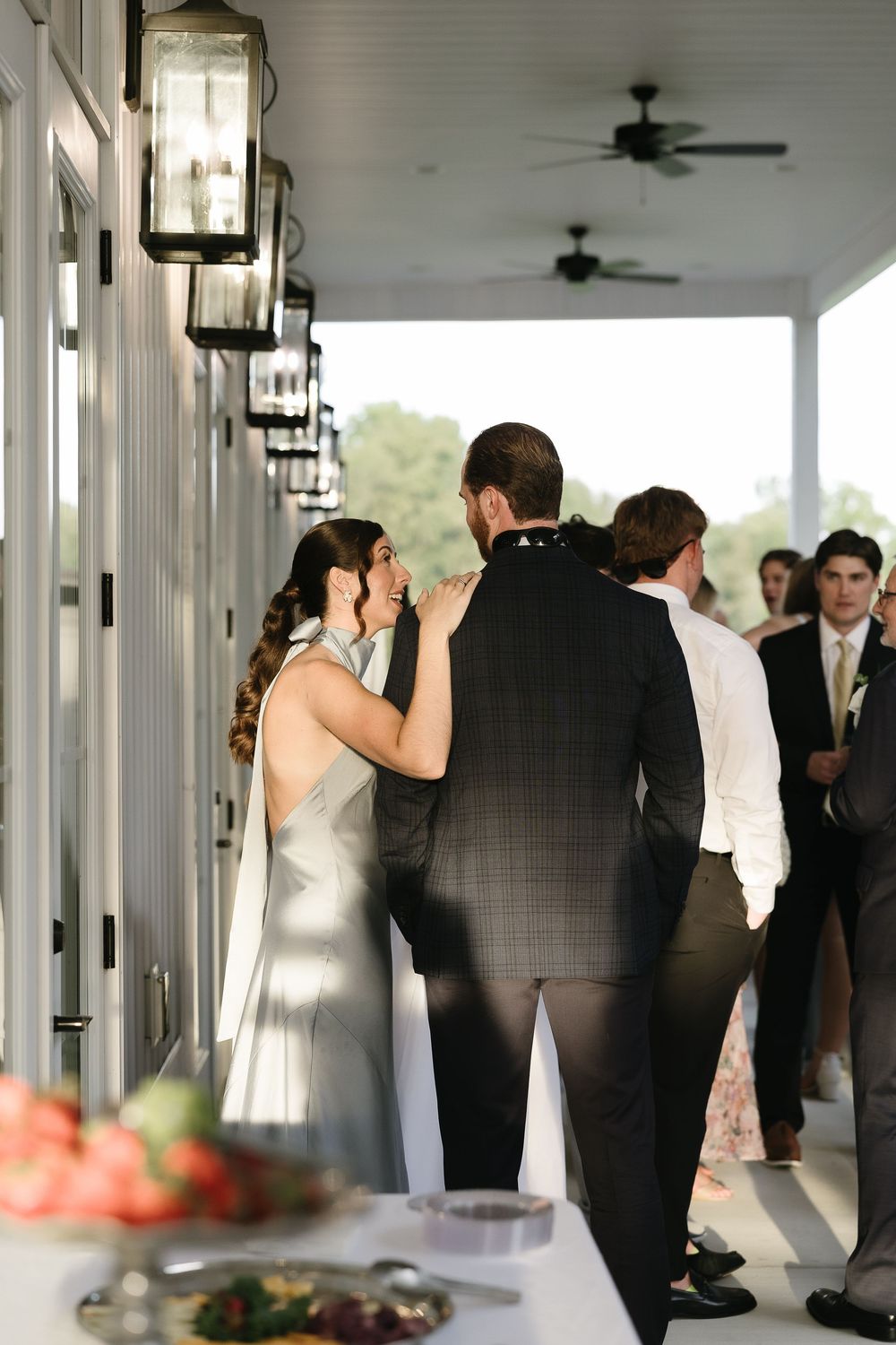 Elegant covered porch with white columns decorated for a wedding celebration.