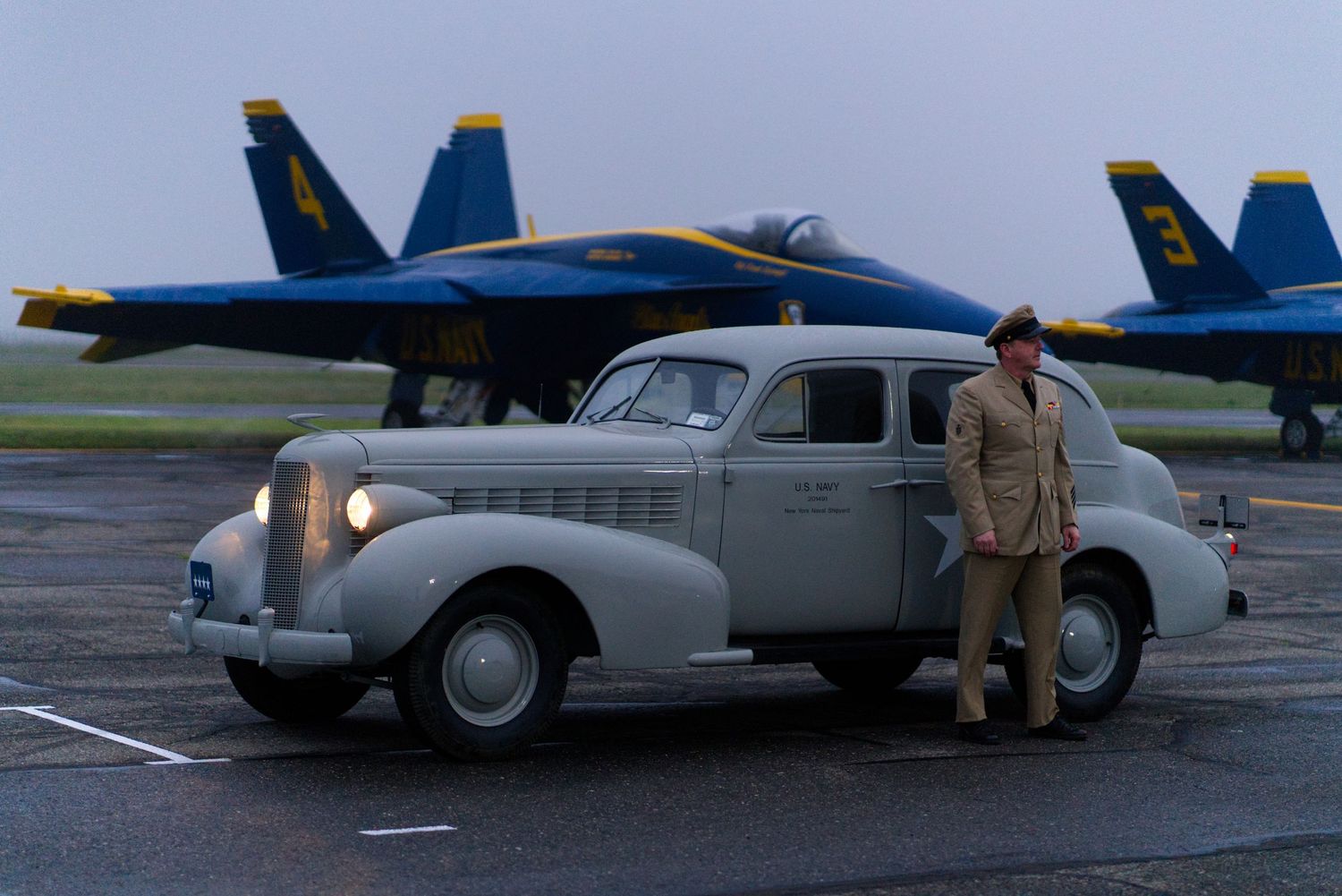 Aviation Portrait. Man with an older WW2 era car, and the blue angels behind