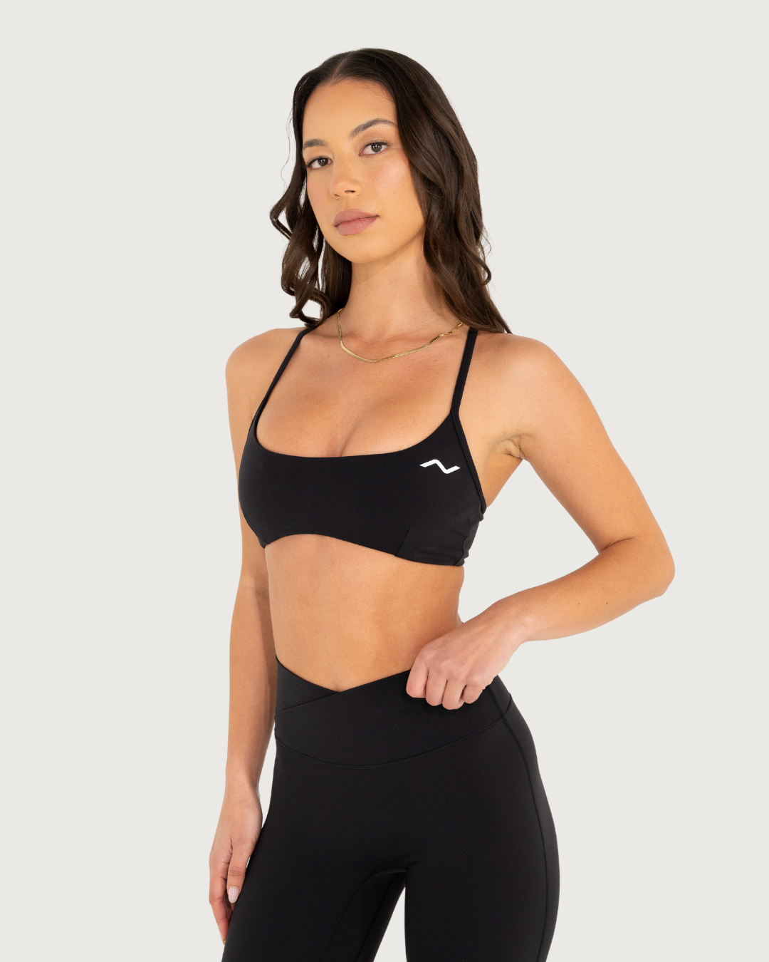 Black sports bra and high-waisted leggings set shown from multiple angles against white background.