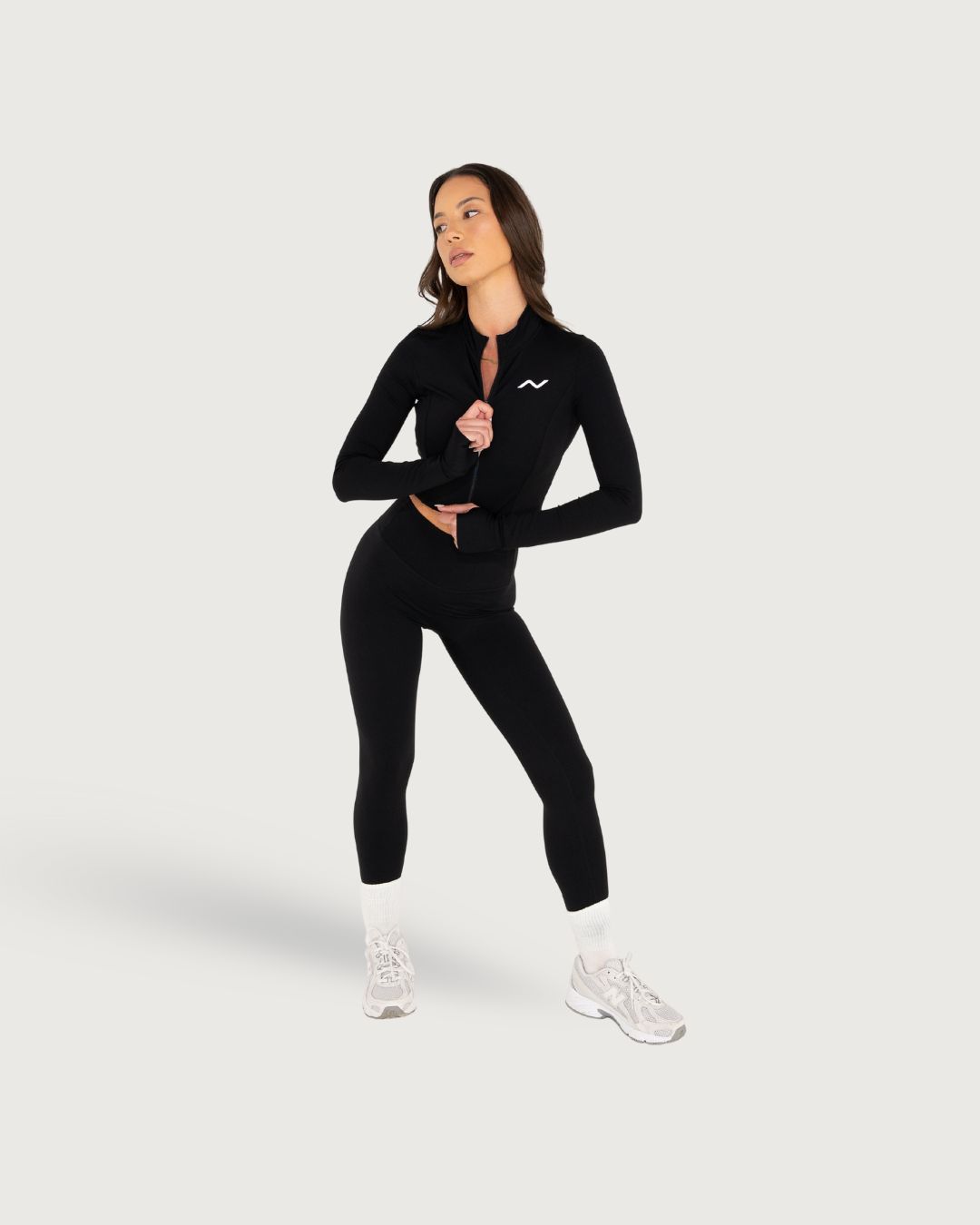 Black athletic wear set shown in multiple angles with long sleeves and fitted pants.