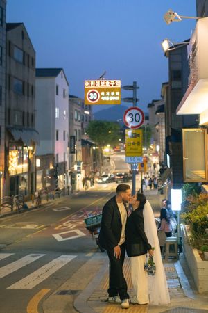 Evening street scene in Korea with city lights and buildings creating a romantic atmosphere.