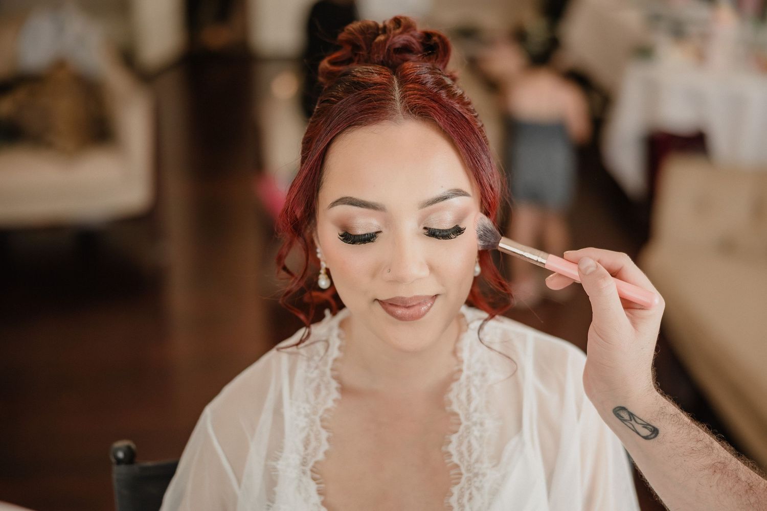 Wedding day preparation with elegant makeup and styling details.