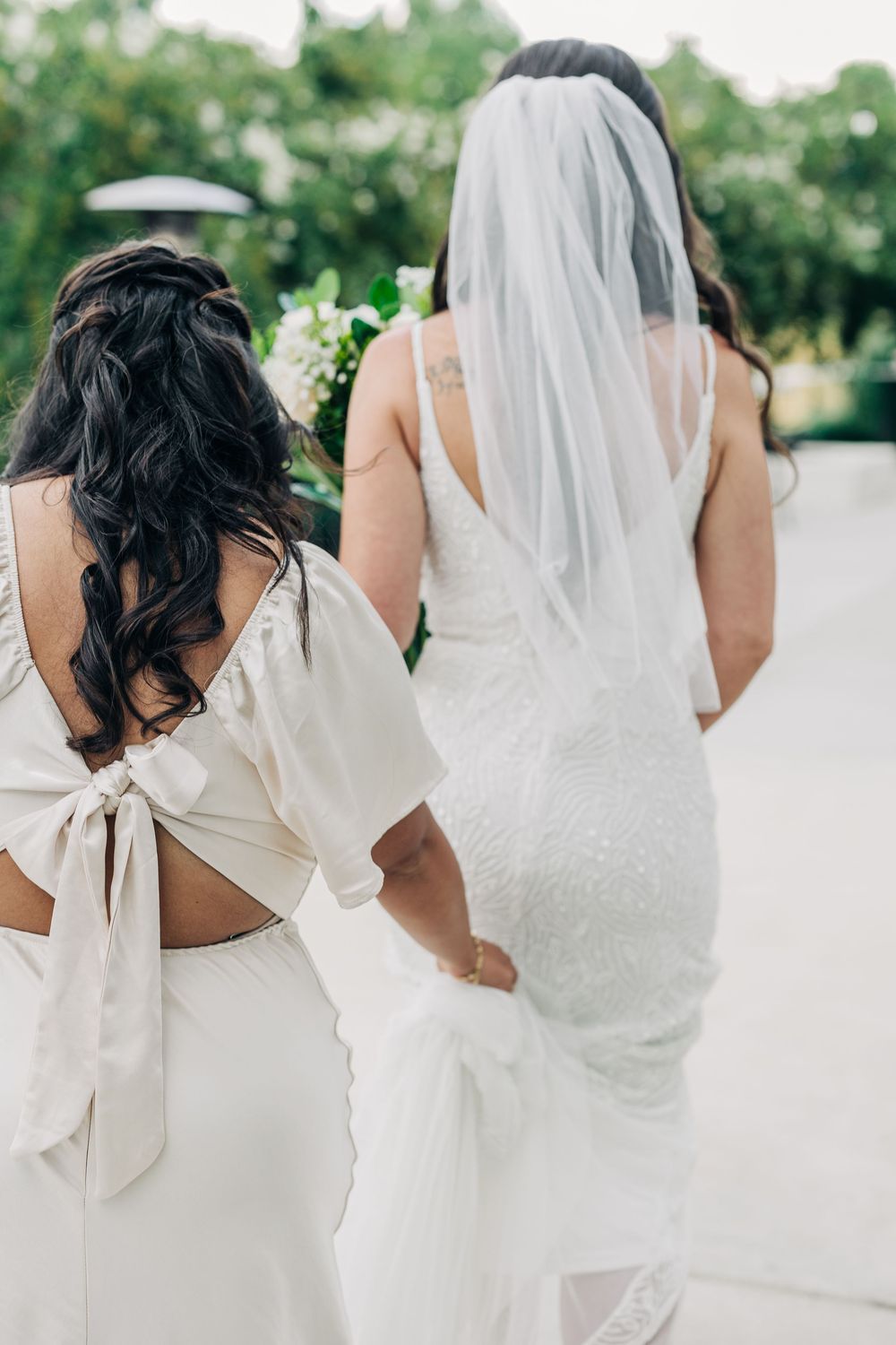 Art composition showing a dreamy wedding bridal party lineup with flowing white dresses and veils.