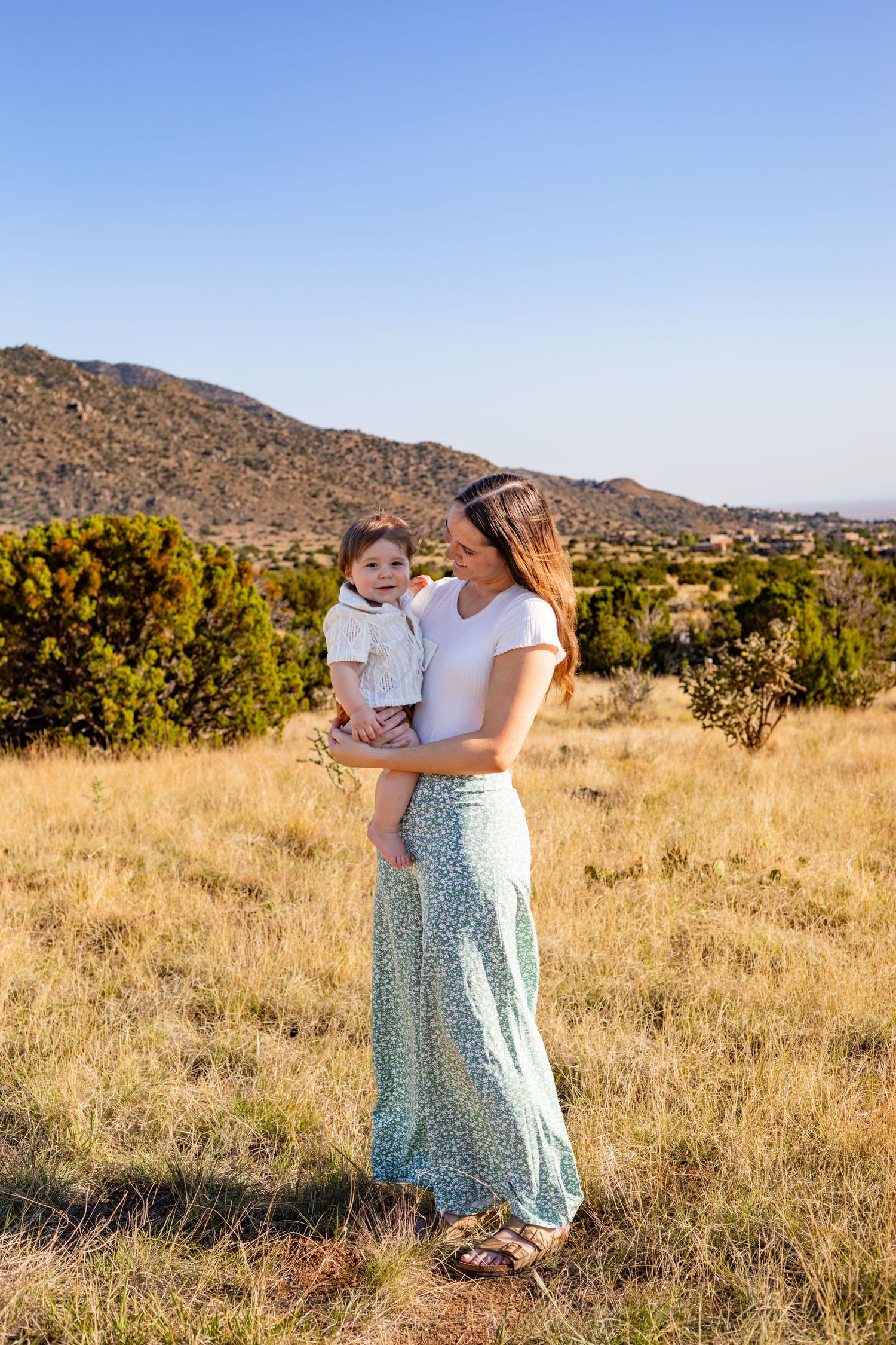 A couple wearing matching black tops pose together. Shot by Elle DeWeese Photography LLC in Albuquerque, New Mexico.