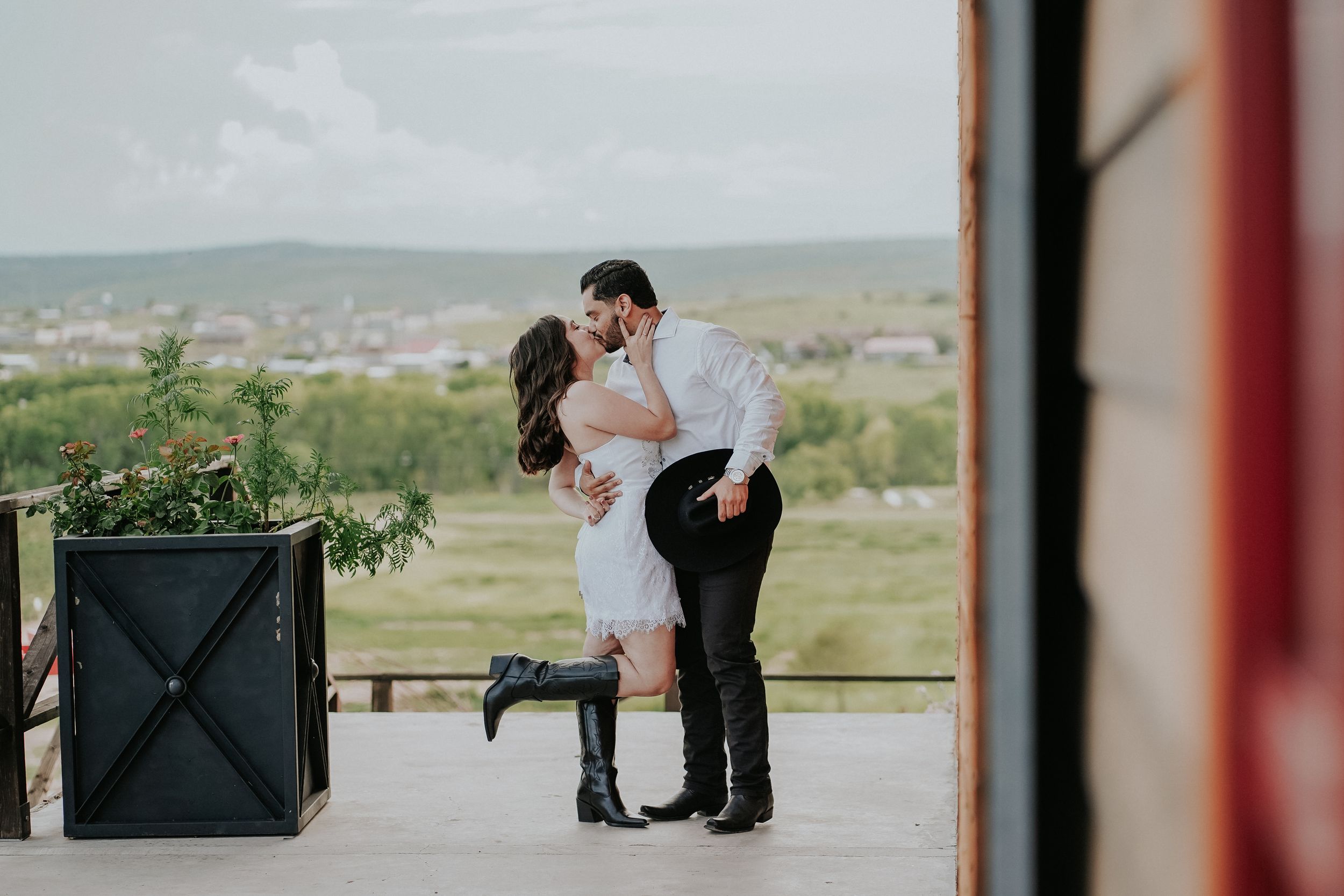 A romantic black and white wedding photo series shows intimate moments between a couple in an outdoor setting.