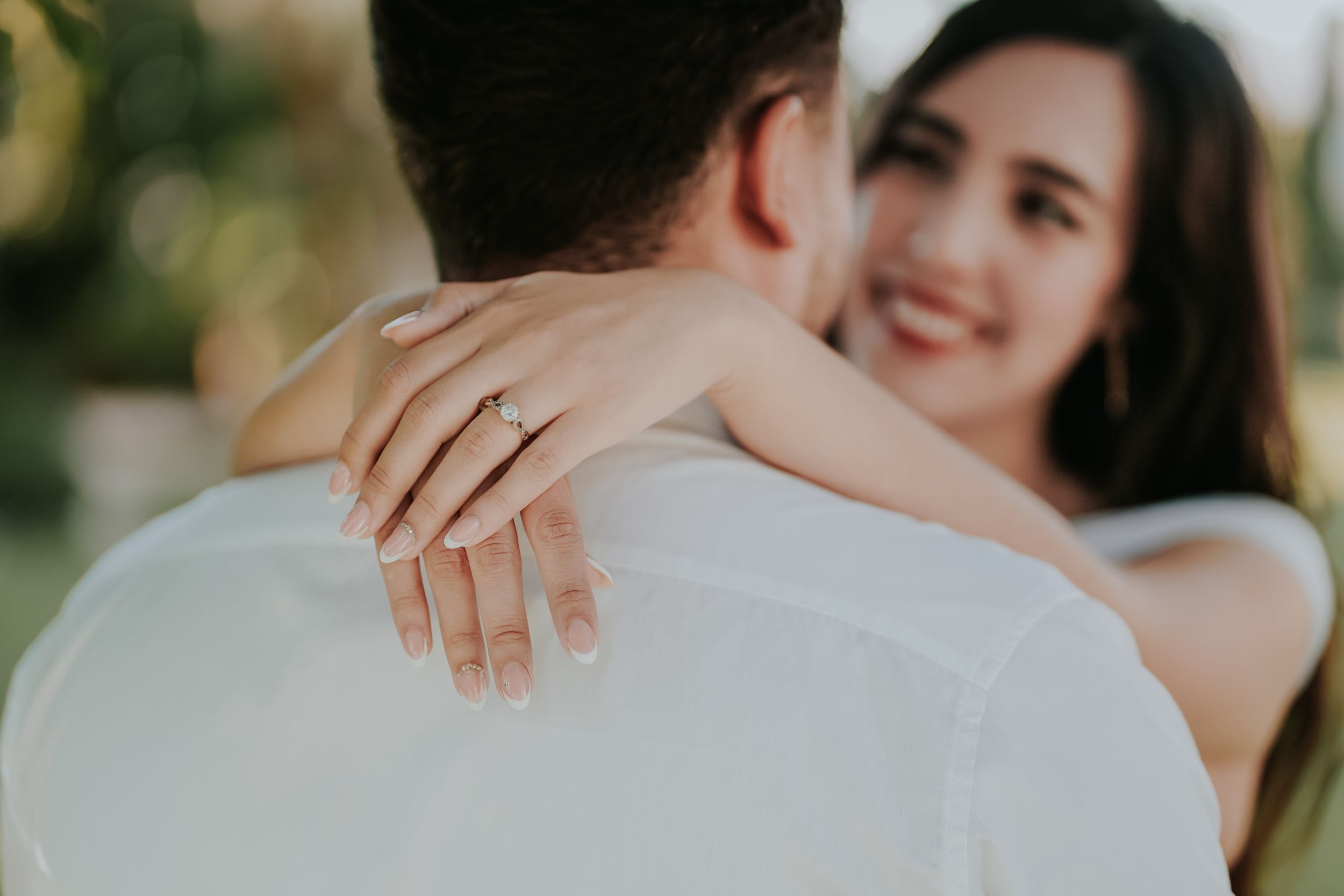 Montage of romantic close-up shots shows wedding couple embracing and interlocking hands with rings.