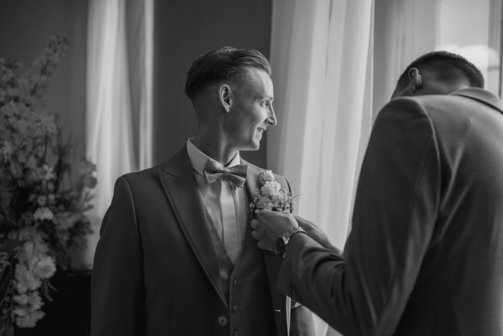 A black and white collage of elegant wedding reception moments showing candid conversation and social interaction.