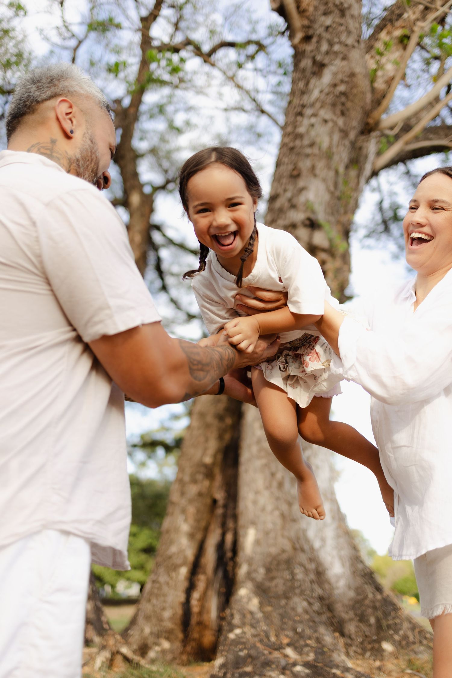 Candid family moments showing playful interactions and genuine joy in an outdoor setting.