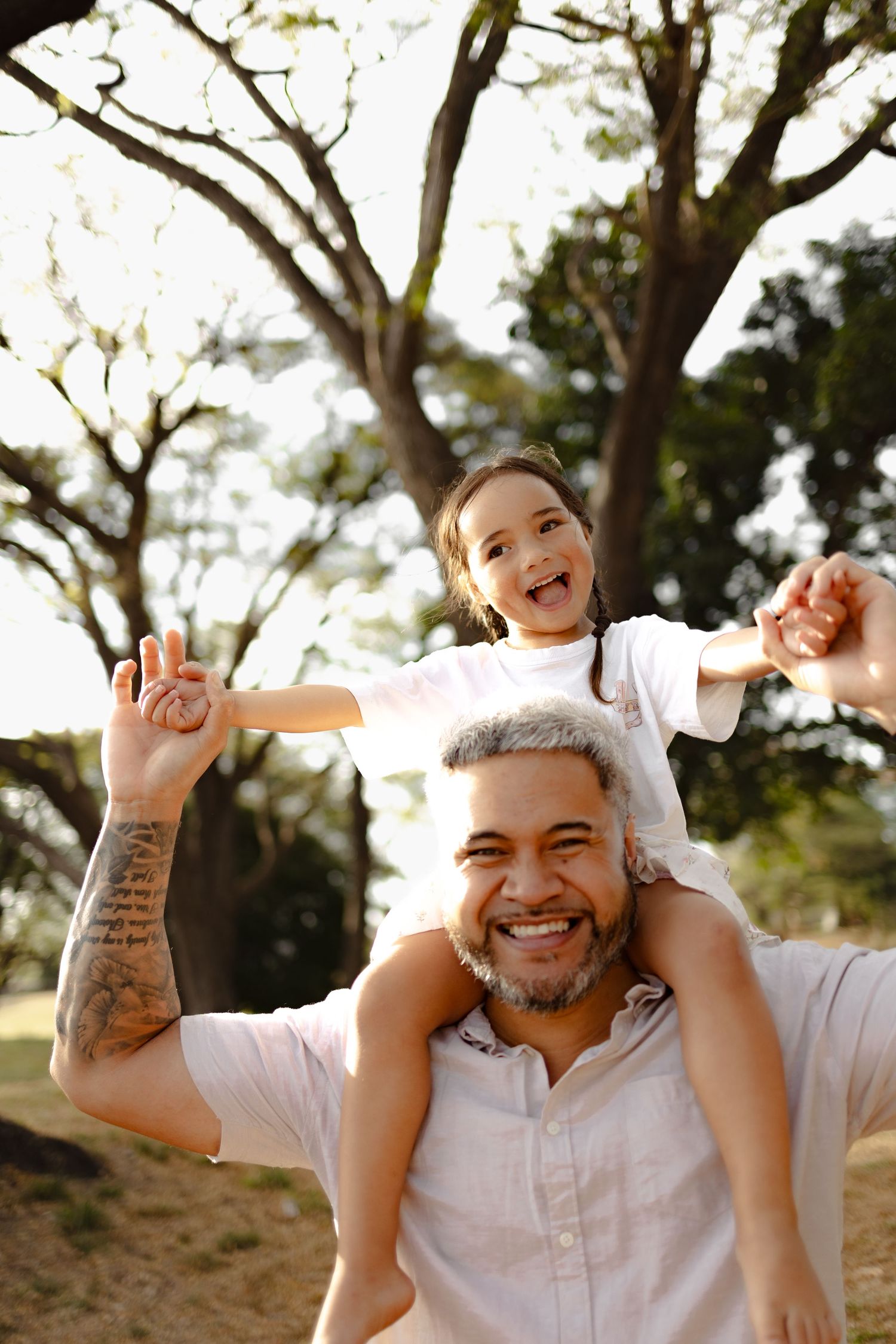Playful piggyback rides and smiles during an outdoor family photoshoot.