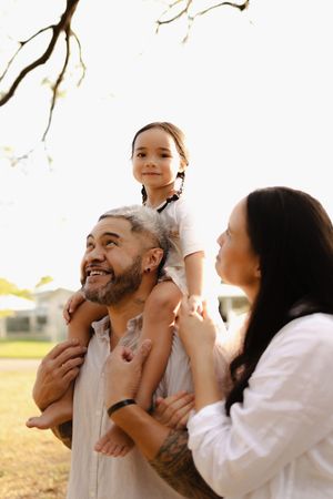Candid family moments captured during golden hour with joyful expressions.