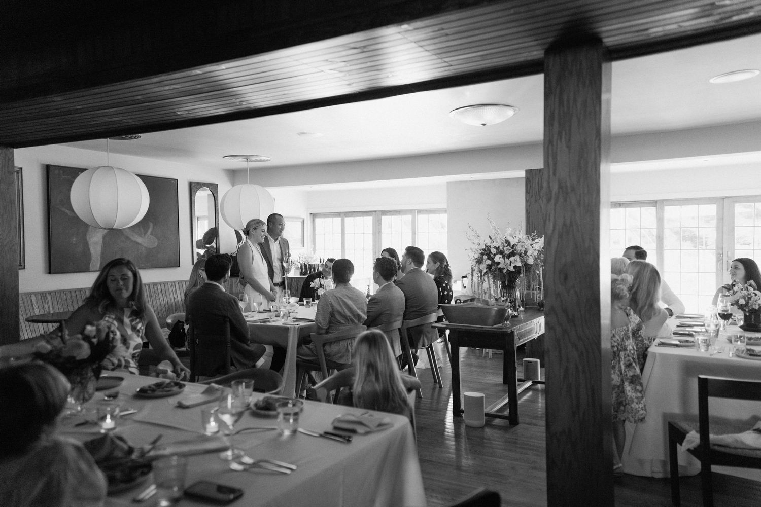 Interior view of a reception venue with tables set for a celebration.
