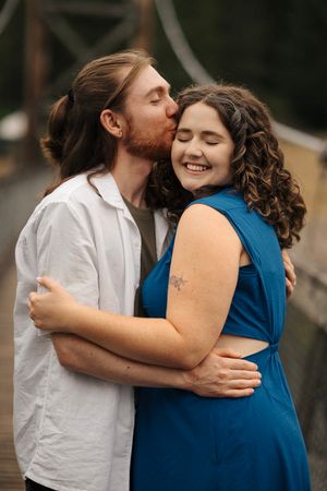 A romantic sequence of intimate embraces between a couple, with one wearing a blue dress and the other in white.